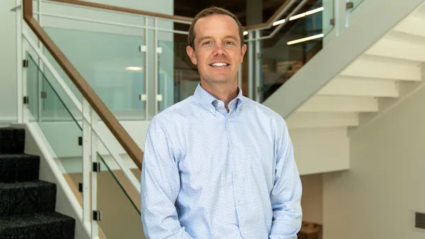 A professional headshot of Greg McHenry.