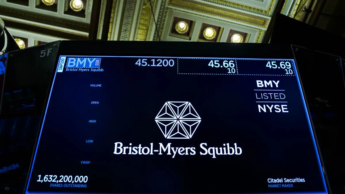 A Bristol Myers logo is displayed on a computer monitor.