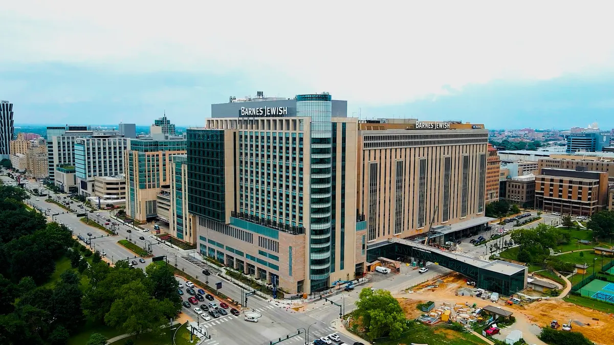 A shot from afar of a large building that occupies a corner. It says "Barnes Jewish" along the top.