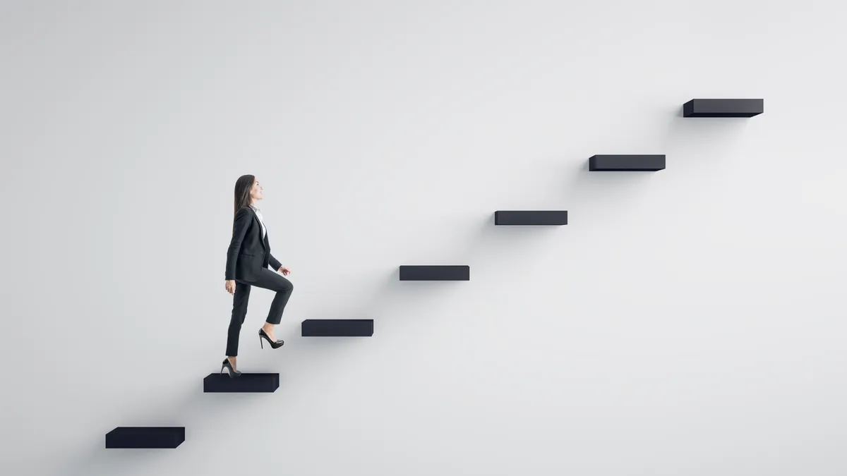 A businessperson climbing stairs to success