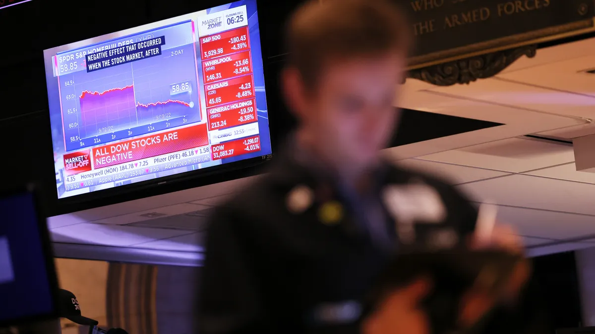 A blurred image of trader on the floor of the New York Stock Exchange.