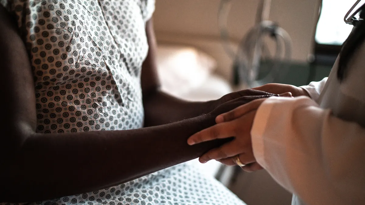 Doctor holding patient's hands