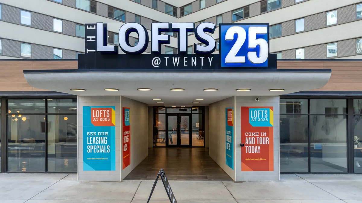 An entryway to an apartment building with a Lofts at Twenty25 sign above.