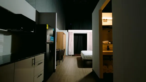 A guest room at a Studio 6 Plus hotel.