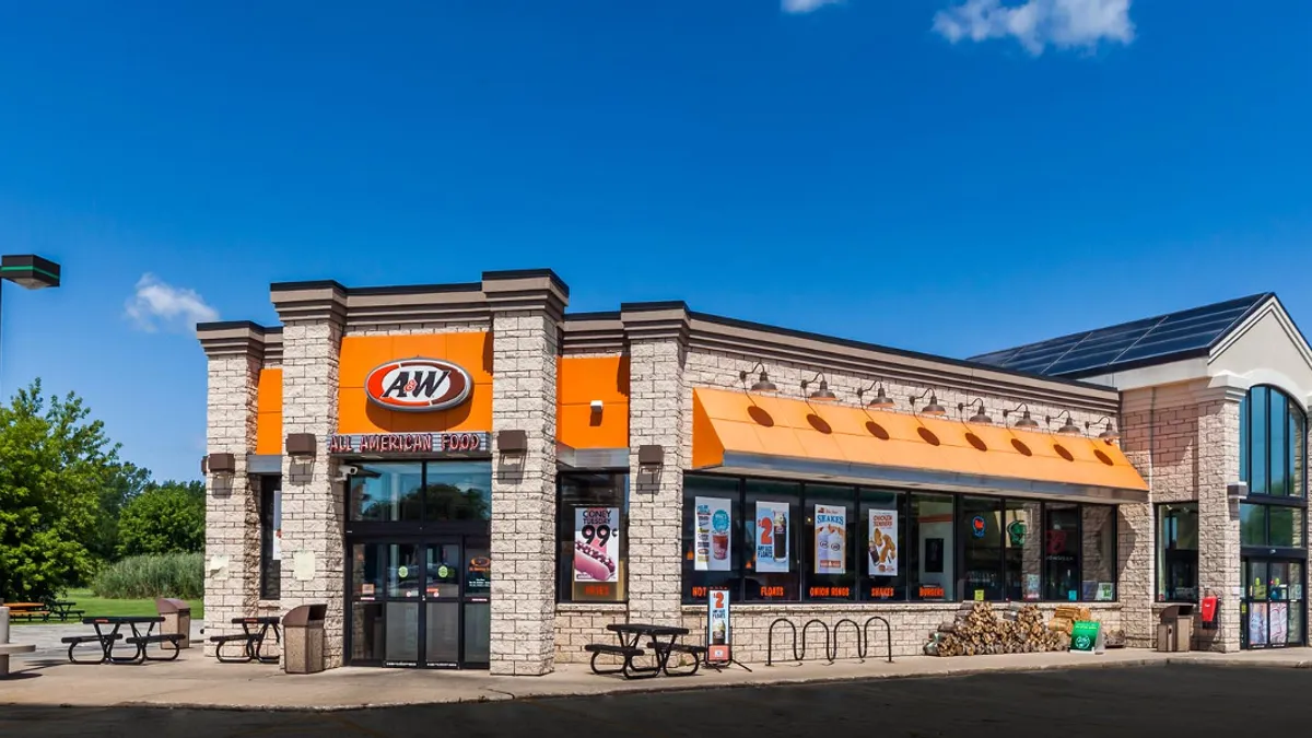 A picture of an A&W located at a gas station.