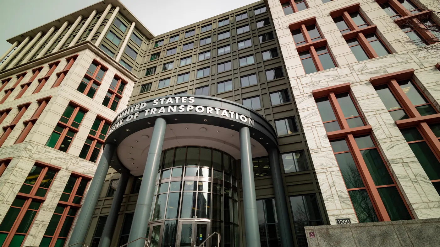 A photo shows the towering presence of the U.S. Department of Transportation building in Washington, D.C.