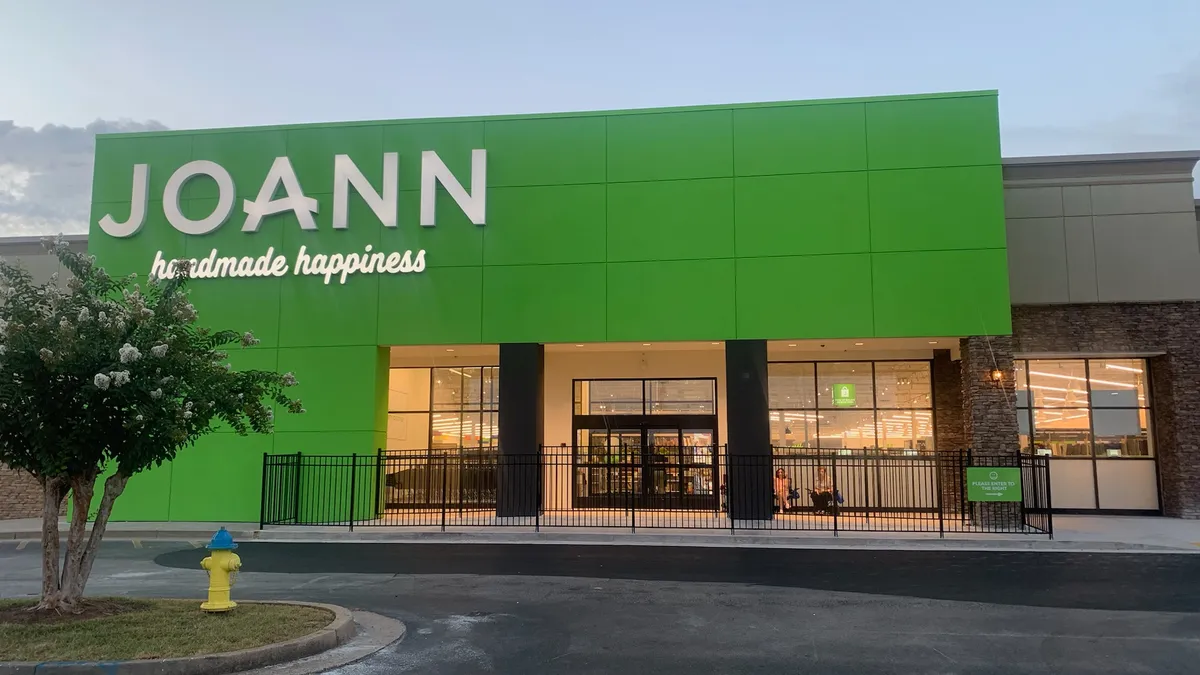 A store with a bright green facade reads "Joann" in capital letters, and in smaller script says "handmade happiness."