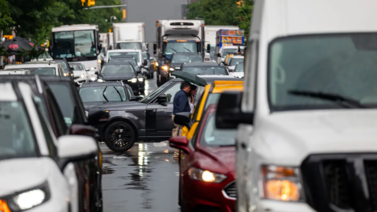 Bumper-to-bumper cars and trucks on a midtown Manhattan street.