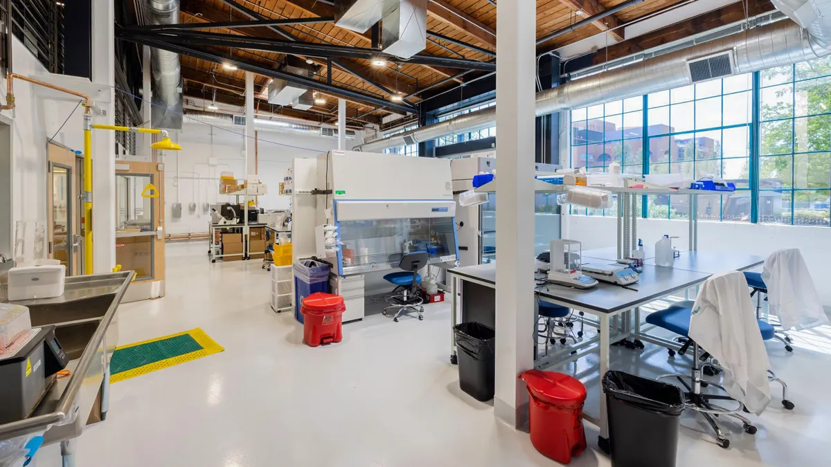 A view of an industrial room with scientific equipments and desks.