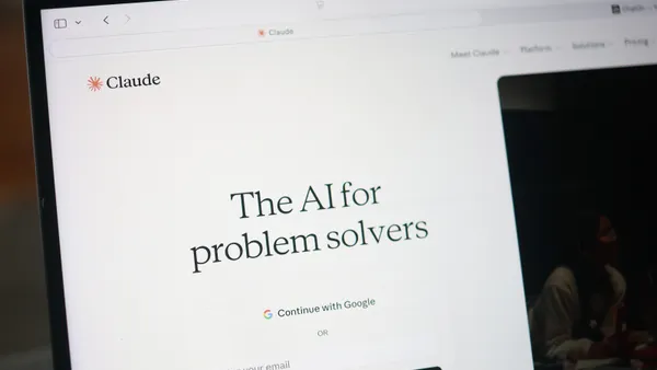 A computer screen shows the website for the AI platform Claude, with the tagline "The AI for problem solvers."