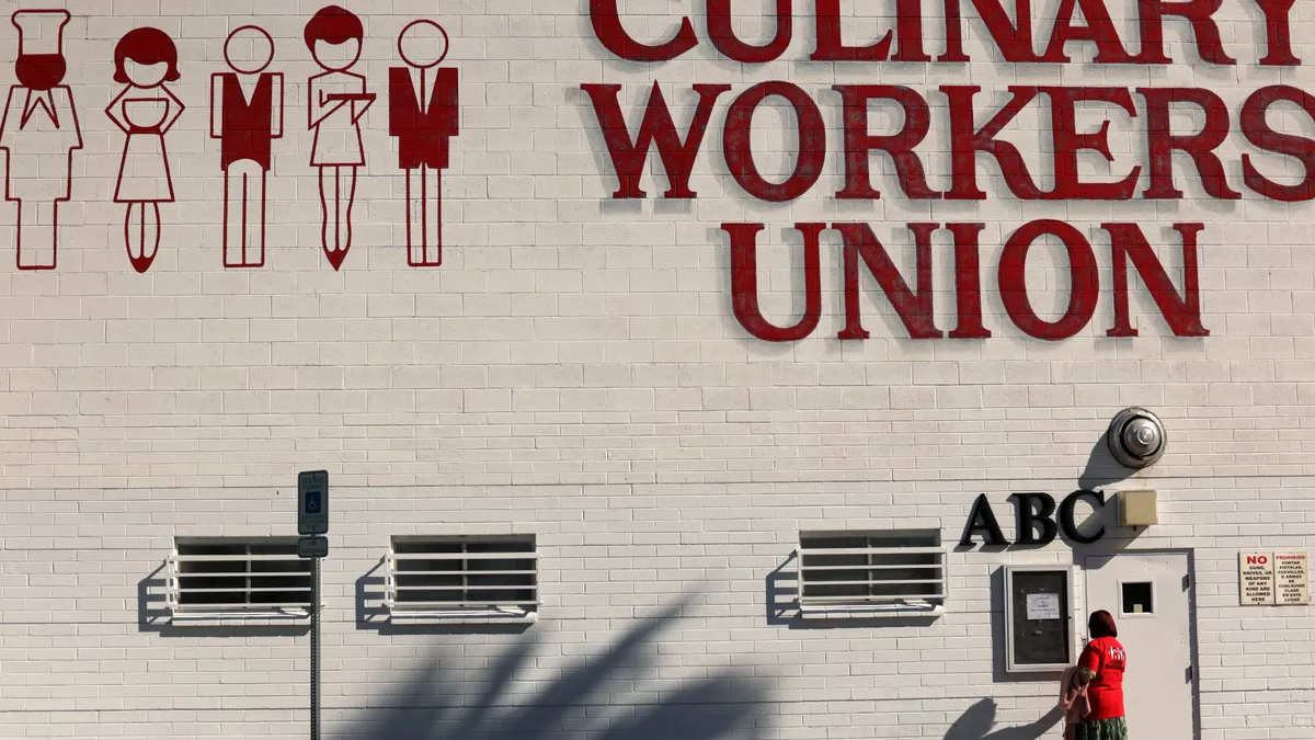 A worker in a red shirt enters the headquarters of the Culinary Union in Las Vegas.