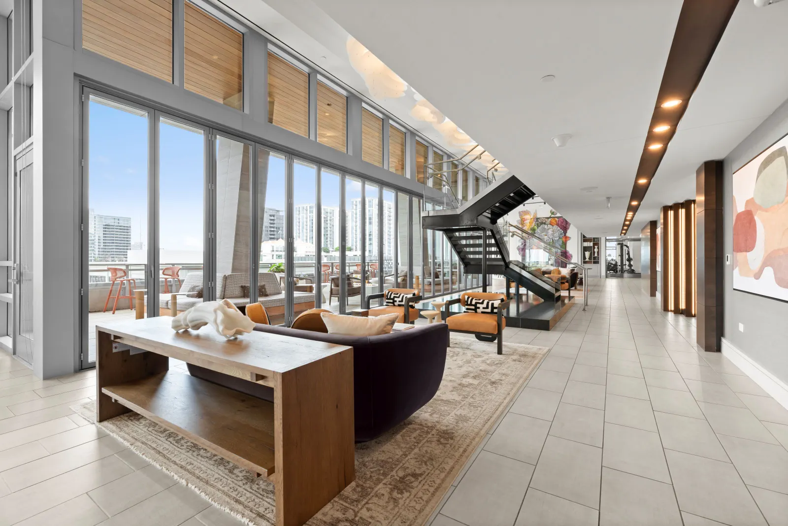 An open space in an apartment building with seating.