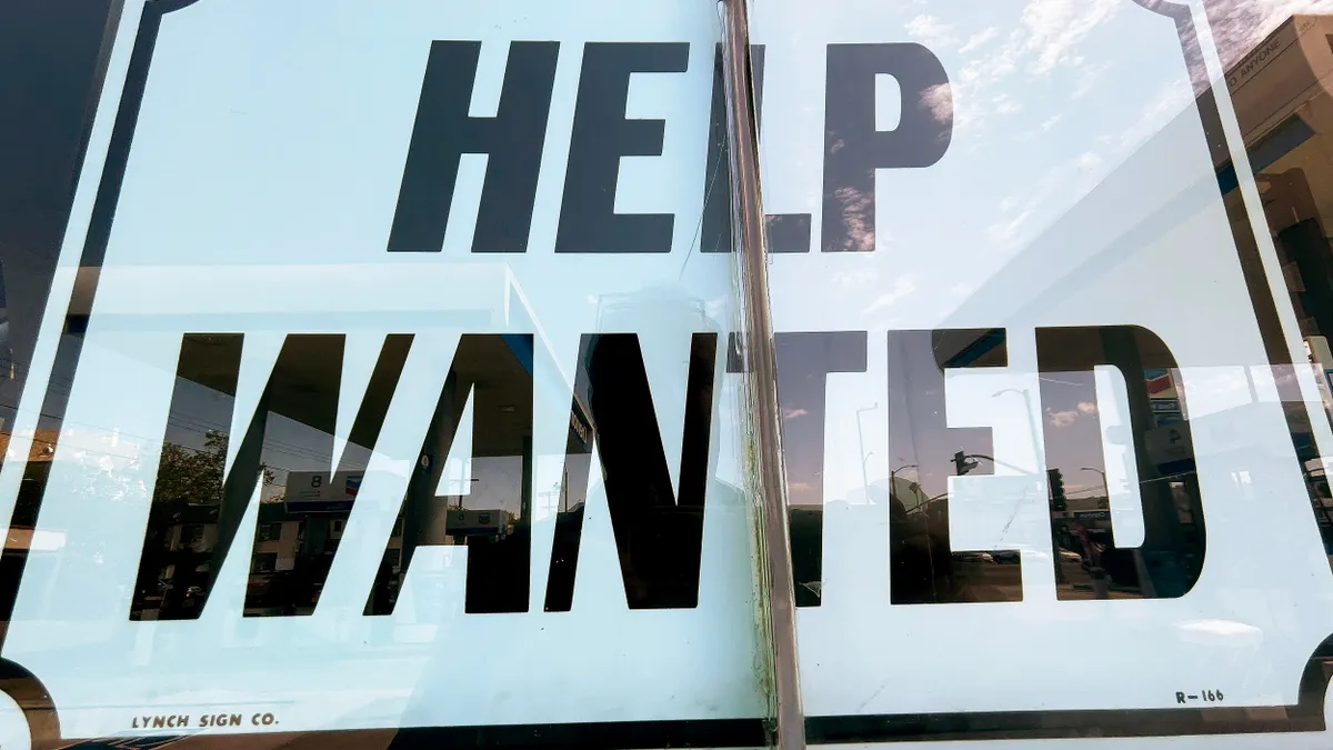 A window shows a large "Help Wanted" sign