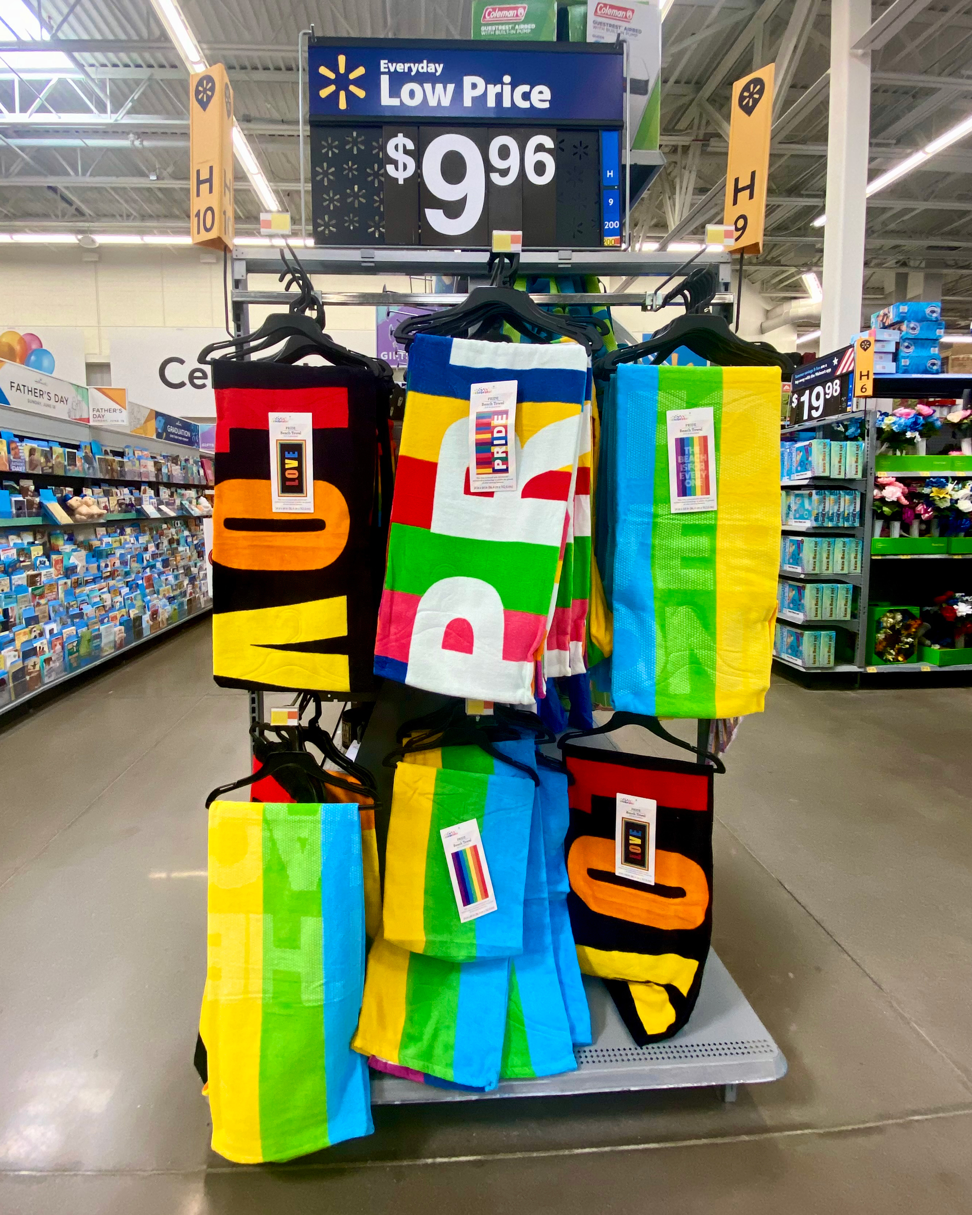 An endcap at a retail store featuring colorful beach towels.