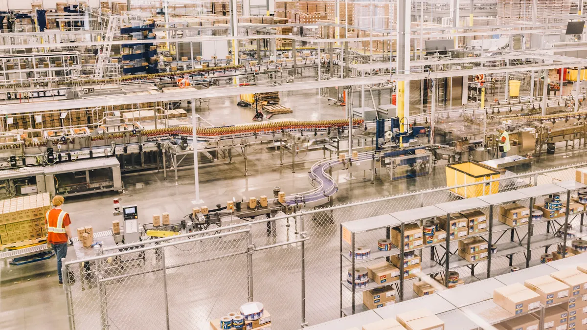 Torani's food manufacturing facility, one person wearing a safety vest walks on the left