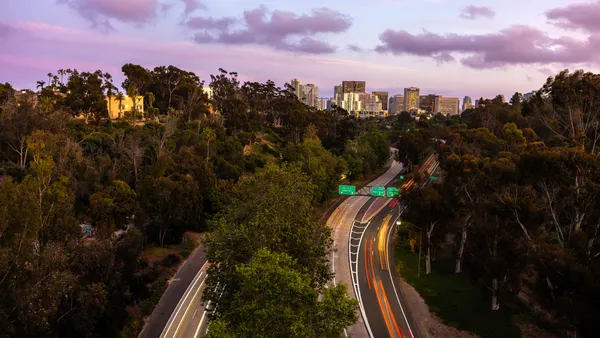 A photo with blurred traffic lights captures the motion of traffic along State Route 163 from Balboa Park in San Diego.