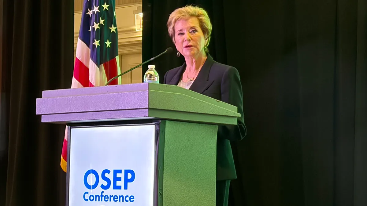 A person stands at a podium. A sign on the podium reads OSEP conference 2026