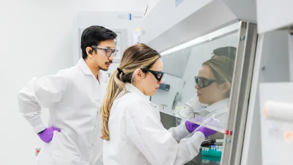 Two people in white lab coats work in Braskem's Renewable Innovation Center in Lexington, Massachusetts