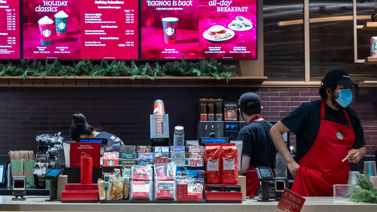 Baristas work in a Starbucks coffee shop in Manhattan on December 02, 2025 in New York City.