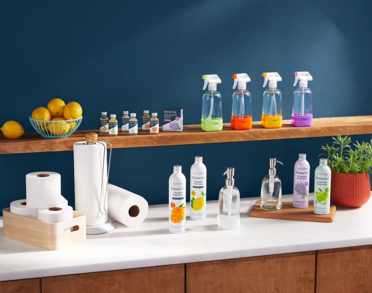 Green shelves with clear and colorful cleaning bottles next to paper towel rolls