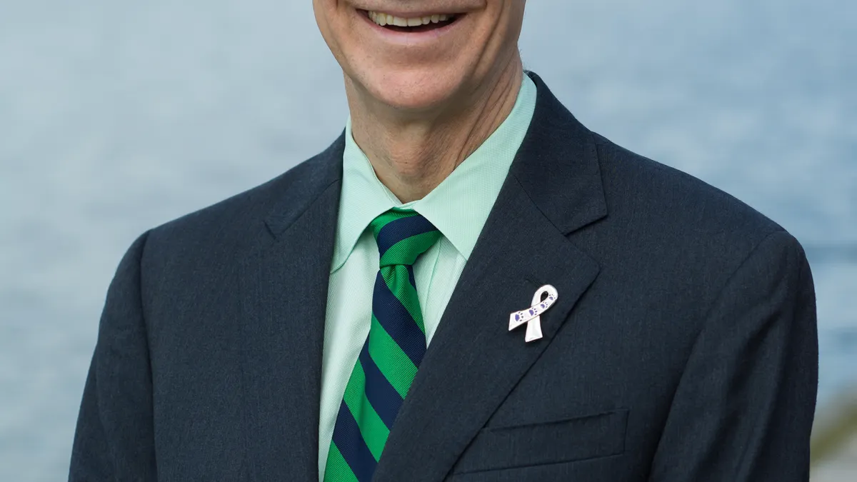Wilson Bryan, of Greenleaf Health, stands for a photo with a river in the background.