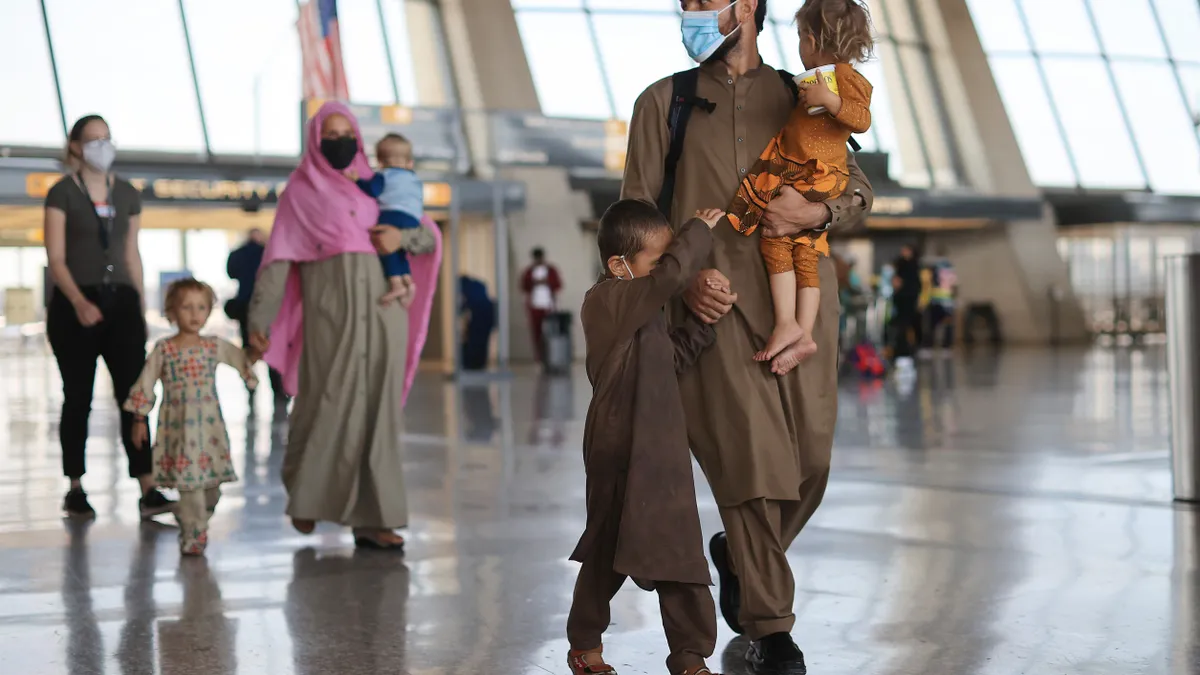 Refugees arrive at Dulles International Airport on August 27, 2021