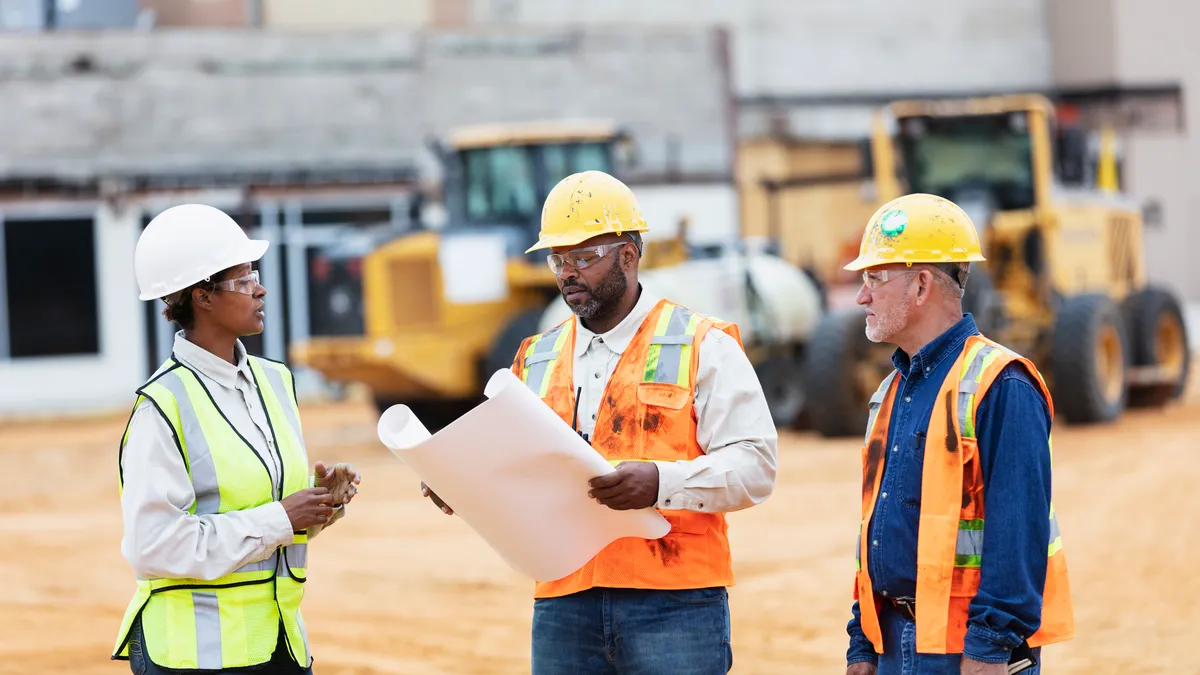 construction workers conversing at job site