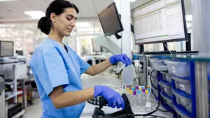 A female hematologist analyzes medical samples at a hospital laboratory.