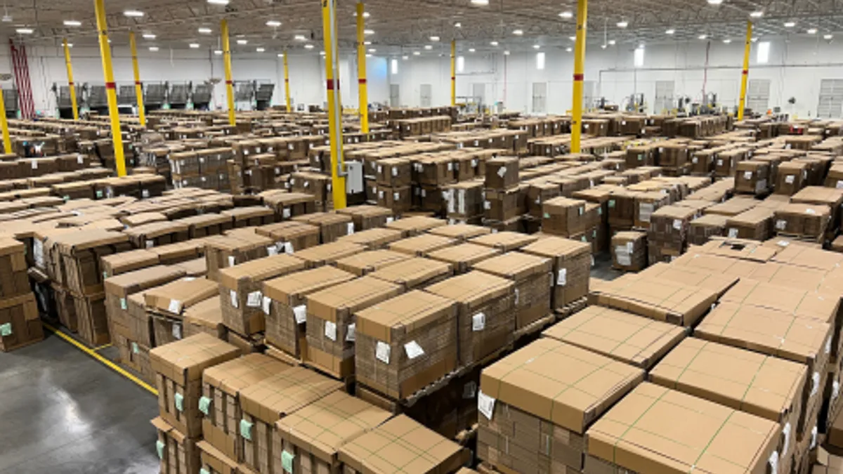 Cardboard boxes stacked in a corrugated packaging warehouse.