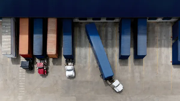 Aerial view of a truck leaving the loading dock at a distribution warehouse