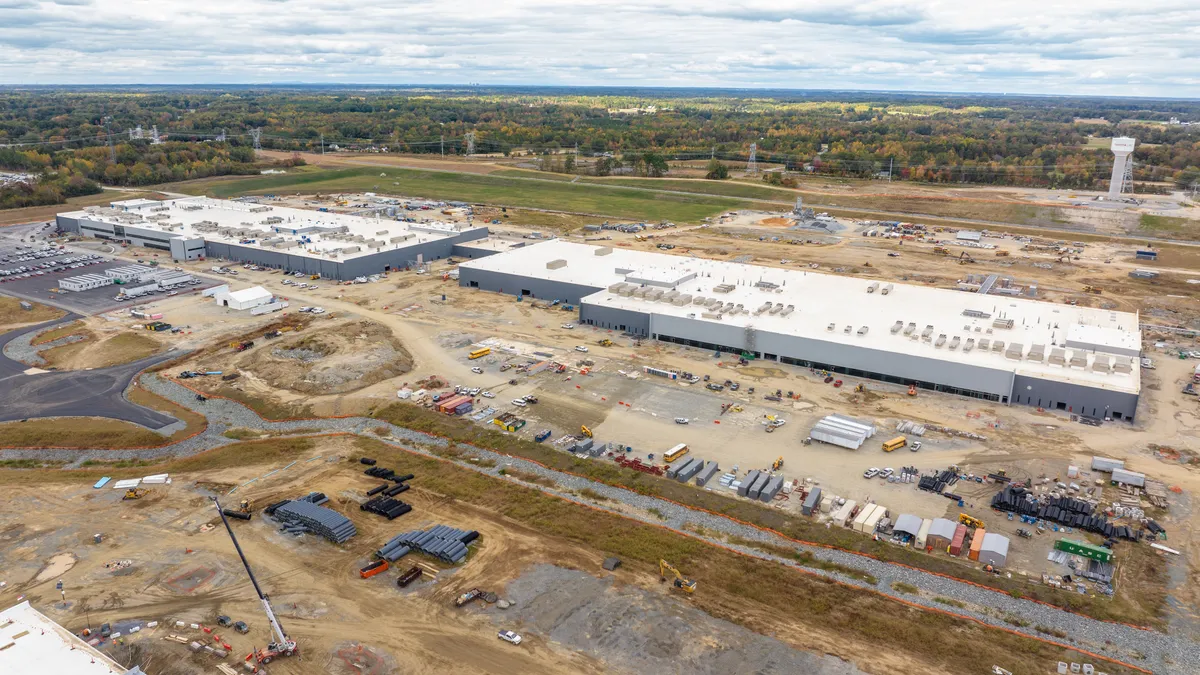 A white building surrounded by dirt and construction.