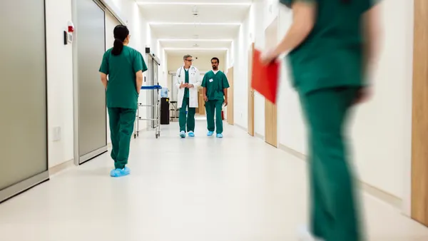 Medical staff walking and talking in hospital corridor