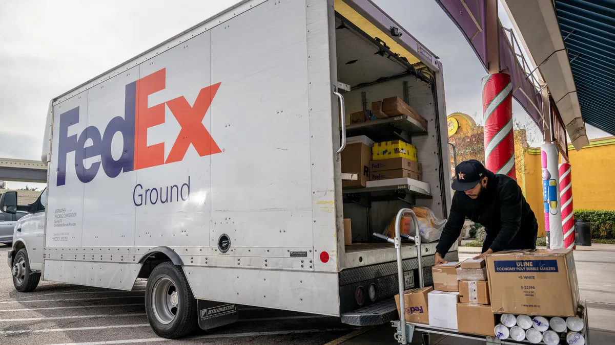 A worker organizes packages at a FedEx facility on December 21, 2022 in Houston, Texas.