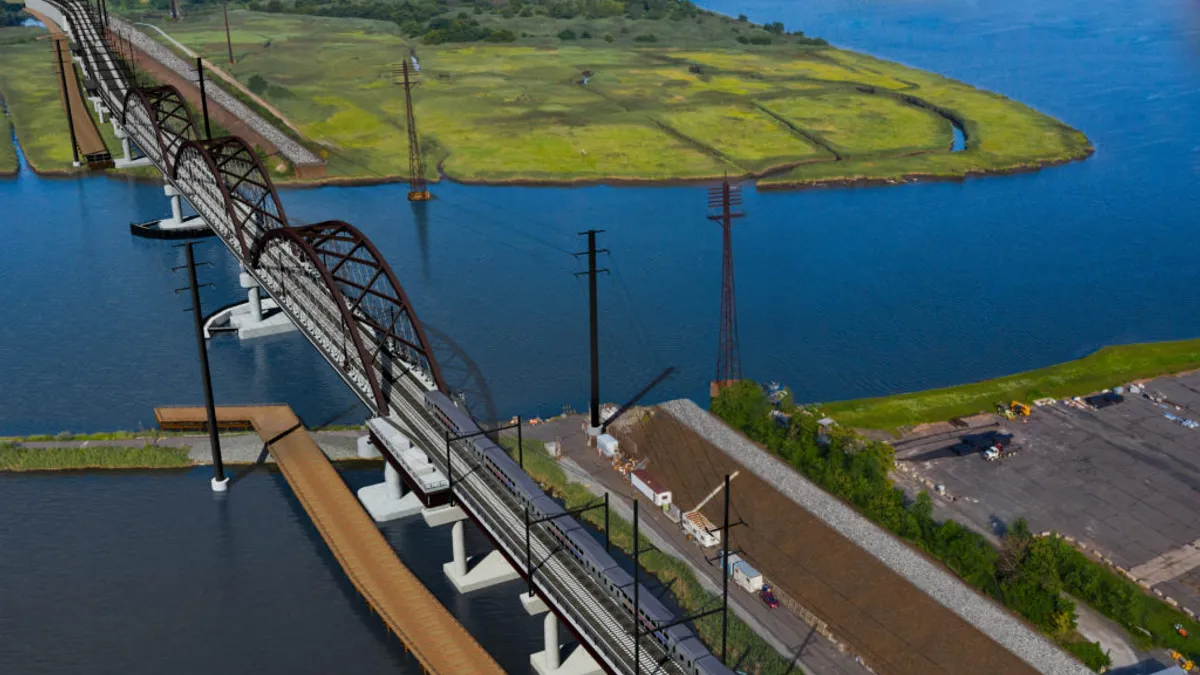 A view of the brown three-span Portal North Bridge from above.