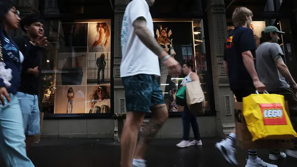 People walk along a shopping street.