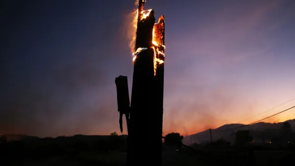 A utility pole burns,