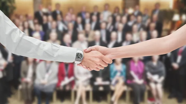 A man and a woman shaking hands