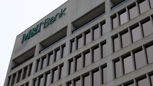 A brutalist-style commercial building containing grided dark windows has a large "M&T Bank" logo at the top corner of the building.