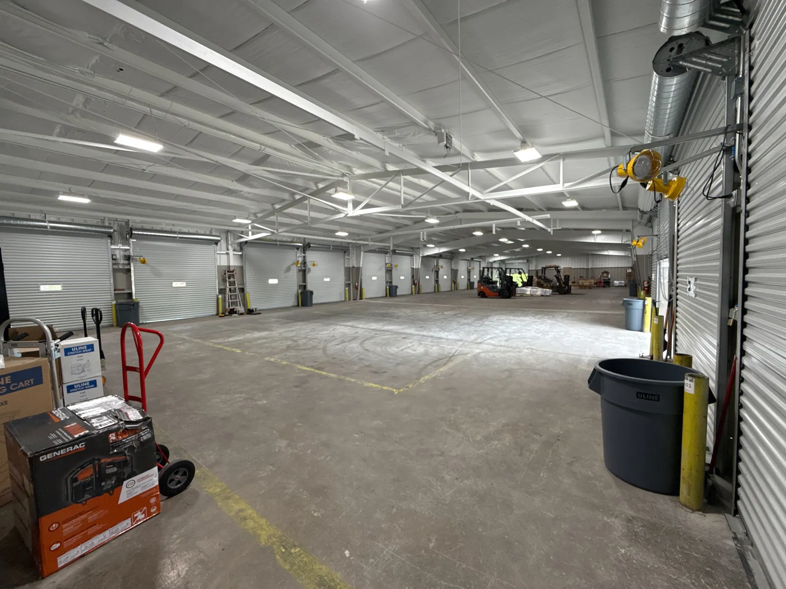 Warehouse equipment inside A. Duie Pyle's facility in Bridgeport, West Virginia, with lights shining.