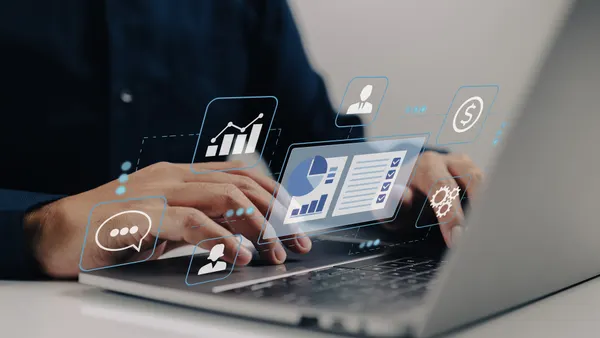 A man uses his business' customer relationship management system on a laptop.