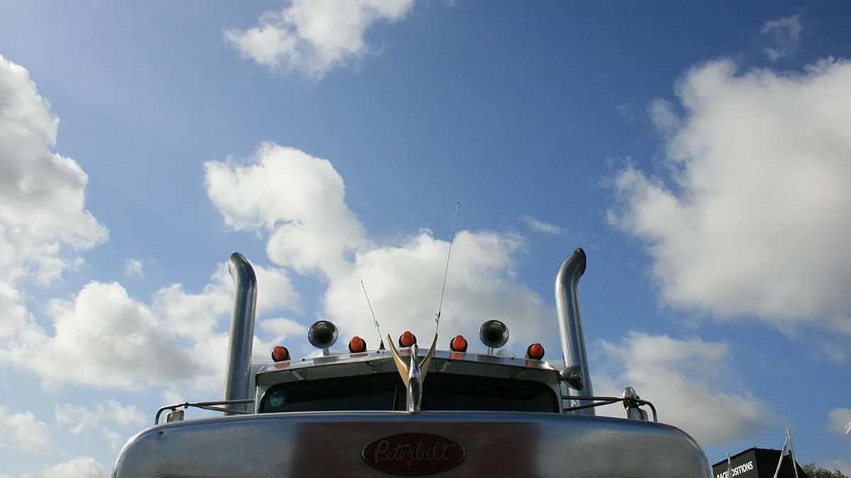 The grill and exhaust pipes of a Peterbilt truck.