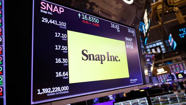 A screen on the floor of the New York Stock Exchange shows Snap's logo and stock information.
