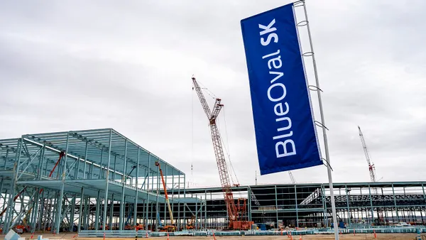 An exterior view of the BlueOval SK battery plant under construction in Tennessee showing the building's steel framing.