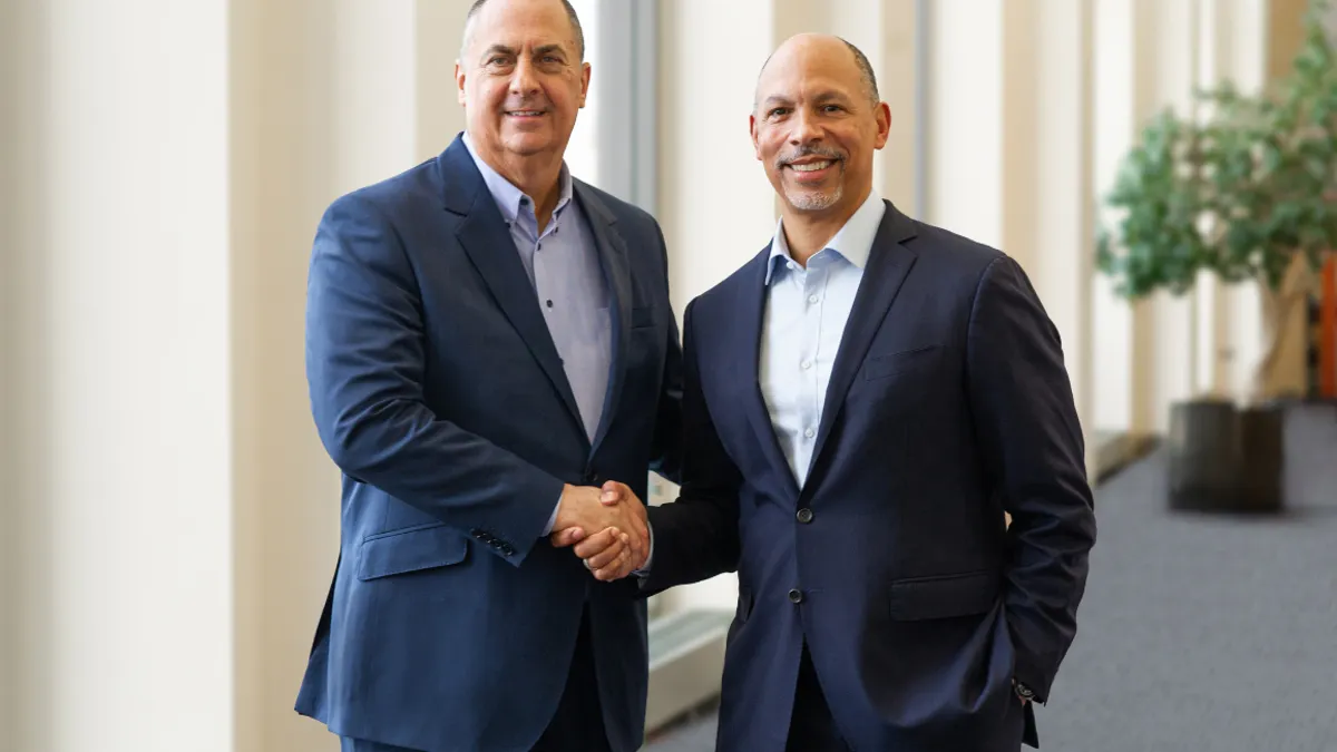 A picture of dual-CEOs of Advocate Health shaking hands