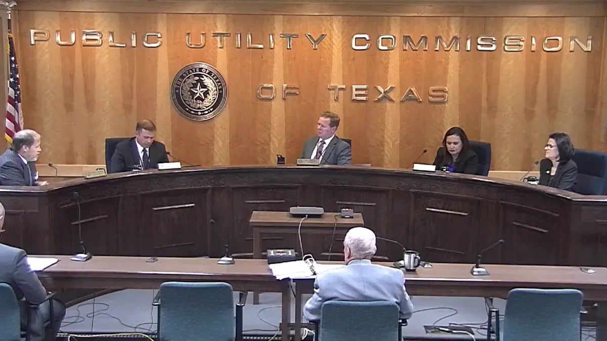 A screenshot of the October 6 Public Utilities Commission of Texas open meeting showing the commissioners.