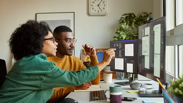 Colleagues discussing over screen