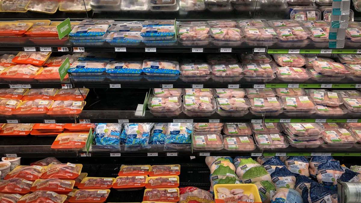 Packaged meat is displayed at a grocery store.