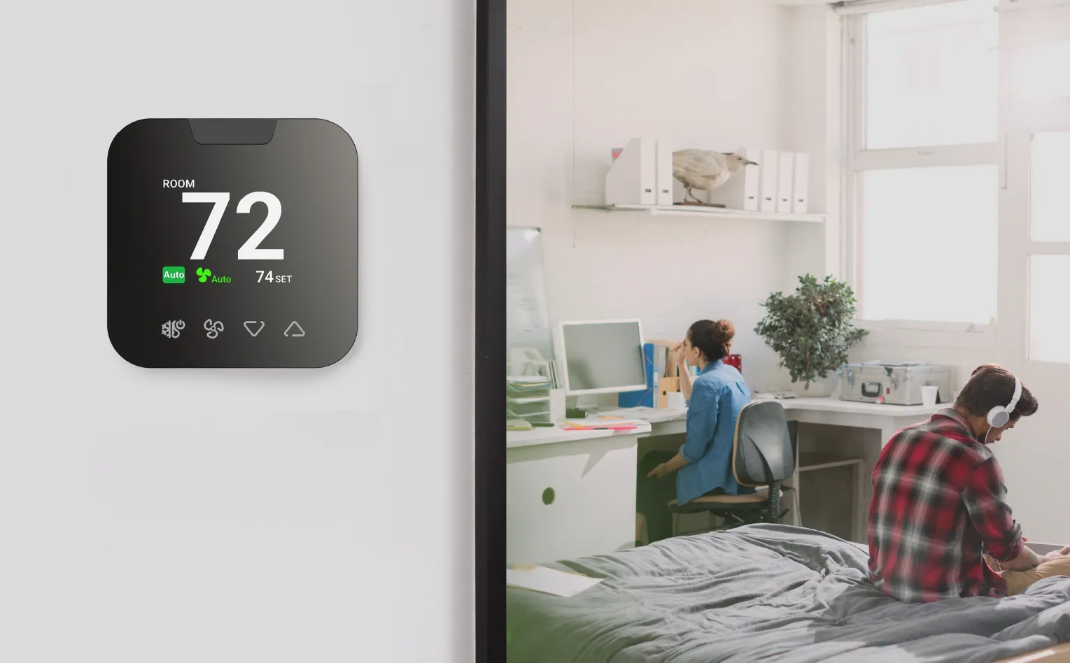A room with a smart thermostat on the wall.