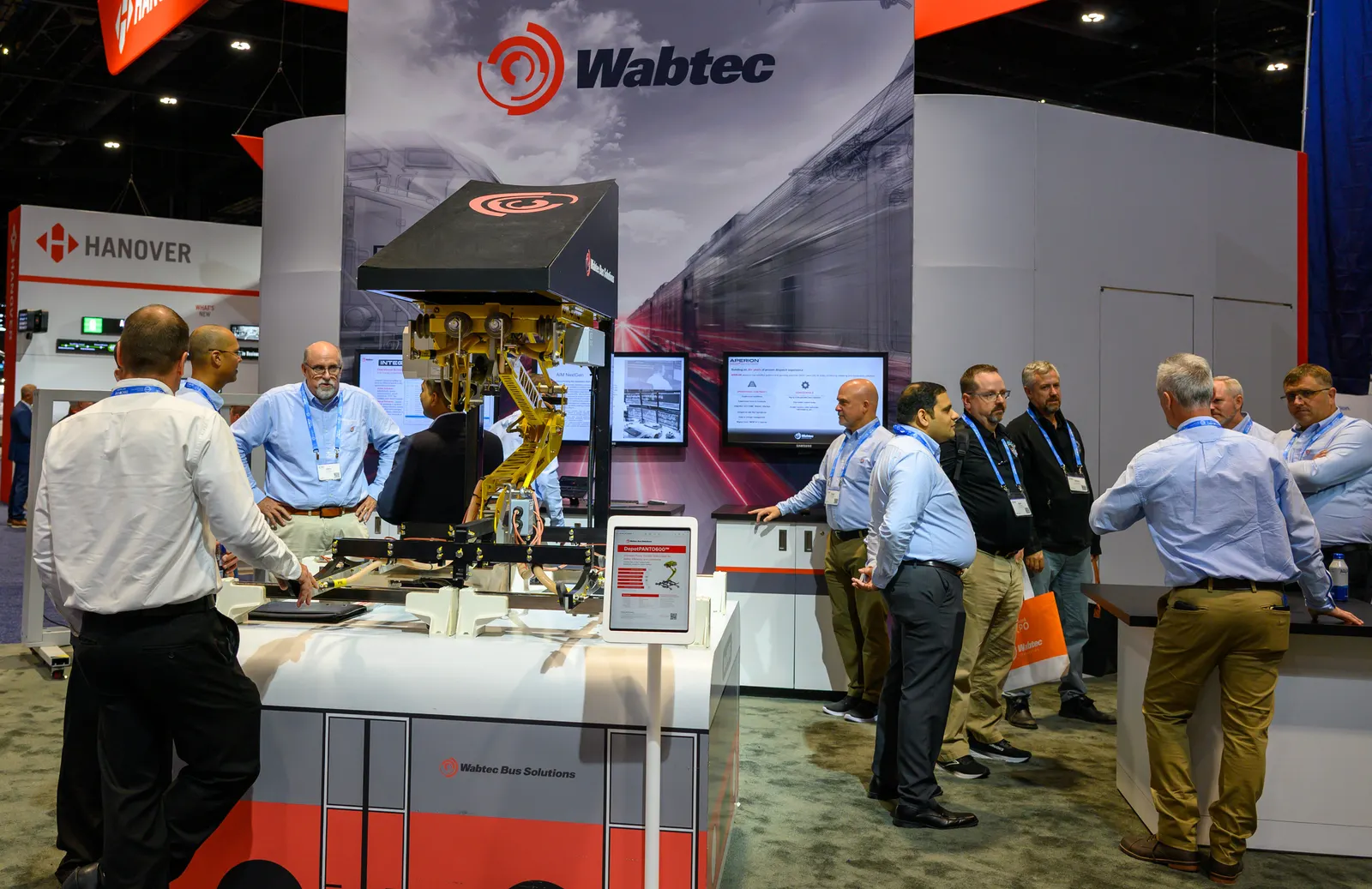 People standing in a display booth labeled Wabtec.