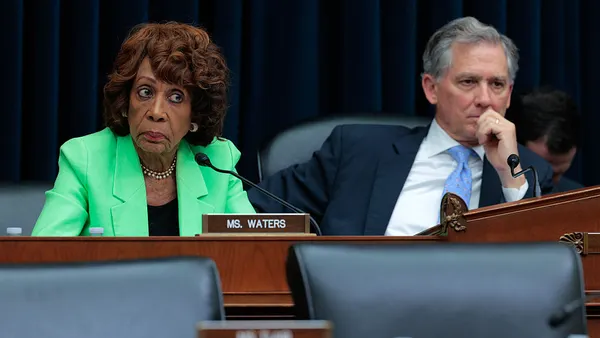 Two representatives in business attire at a hearing.